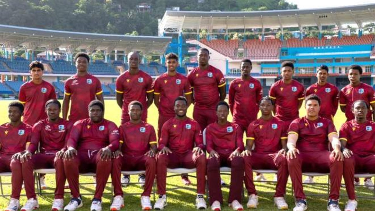Group photo of the West Indies men's cricket team in maroon uniforms at a stadium before a match or training session
