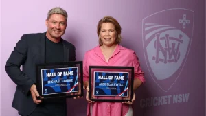 Alex Blackwell and Michael Clarke inducted into Cricket NSW Hall of Fame, holding framed certificates against a purple backdrop
