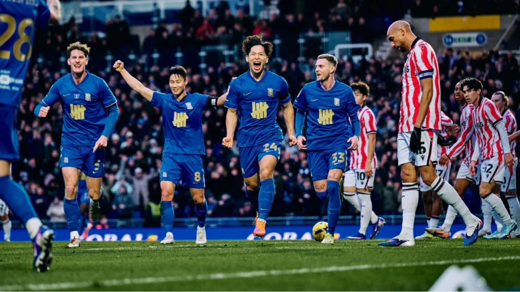 Birmingham City FC players celebrate a goal during a match, highlighting club ownership by Knighthead Capital
