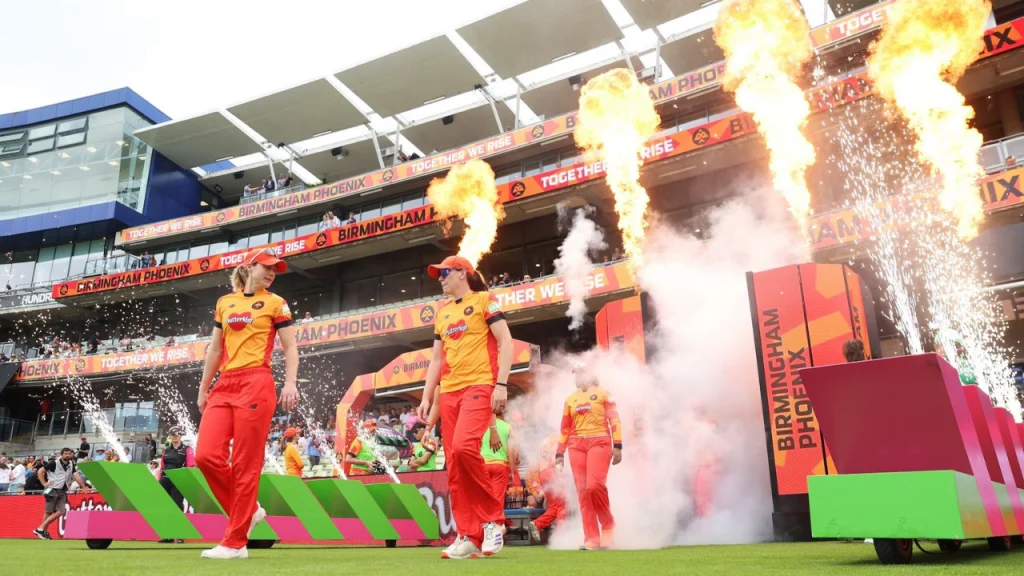 Birmingham Phoenix women's cricket team making a dramatic entrance with fireworks and flames at a The Hundred match