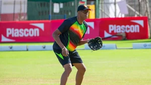 Courtney Walsh wearing a Zimbabwe cricket practice jersey during a training session on the field.