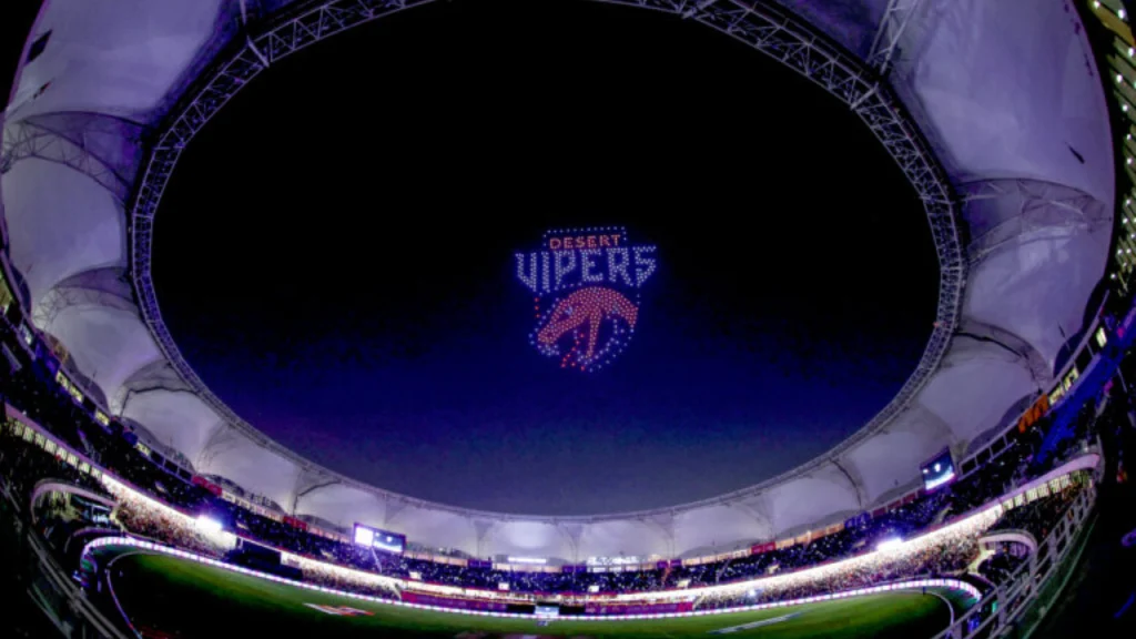 Desert Vipers logo displayed in the sky through a drone light show during ILT20 2026 opening ceremony at a packed stadium