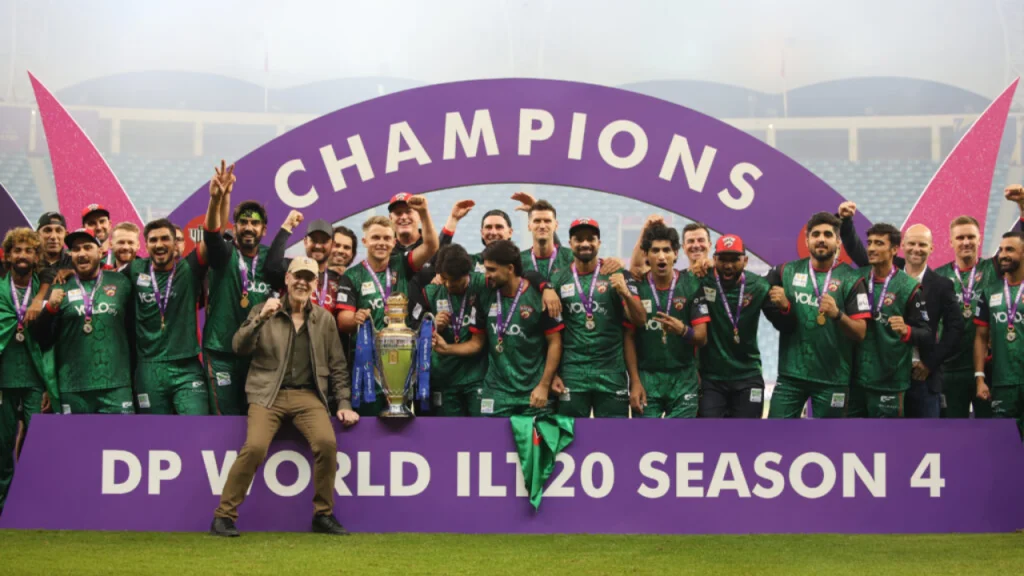 Desert Vipers celebrate ILT20 2026 championship victory with trophy and medals under 'Champions' arch at DP World Season 4 final