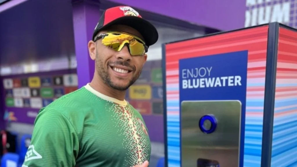 Desert Vipers player smiling next to Bluewater hydration station during ILT20 2026 as part of sustainability initiative