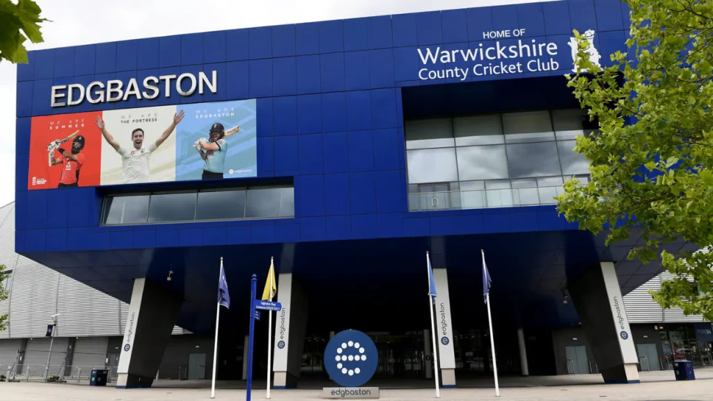 Edgbaston Stadium in Birmingham, home of Warwickshire County Cricket Club, with branded signage and promotional cricket banners at the entrance.