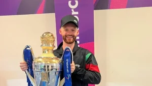 Desert Vipers ILT20 Head Analyst Freddie Wilde smiling while holding the DP World ILT20 trophy