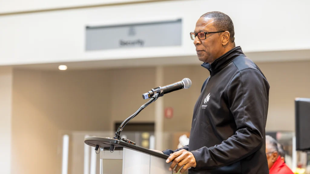 Ingleton Liburd, General Manager of Cricket Canada, speaking at a podium during an official event.