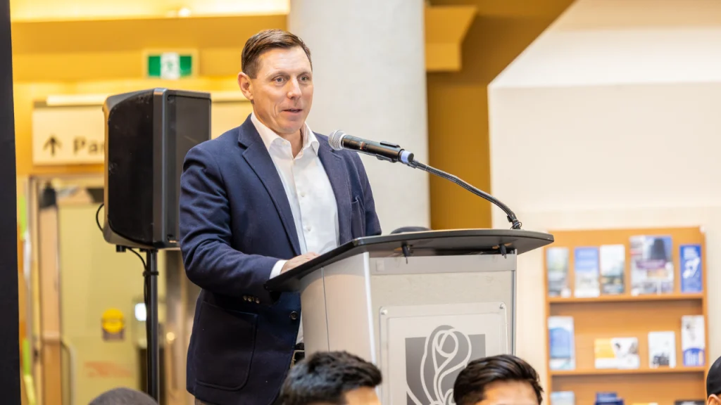 Brampton Mayor Patrick Brown speaking at a podium during a public event inside a community or civic space.