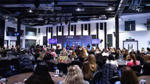 Audience attending the PCA International Women’s Day event focused on inspiring inclusion in sport, with panelists on stage
