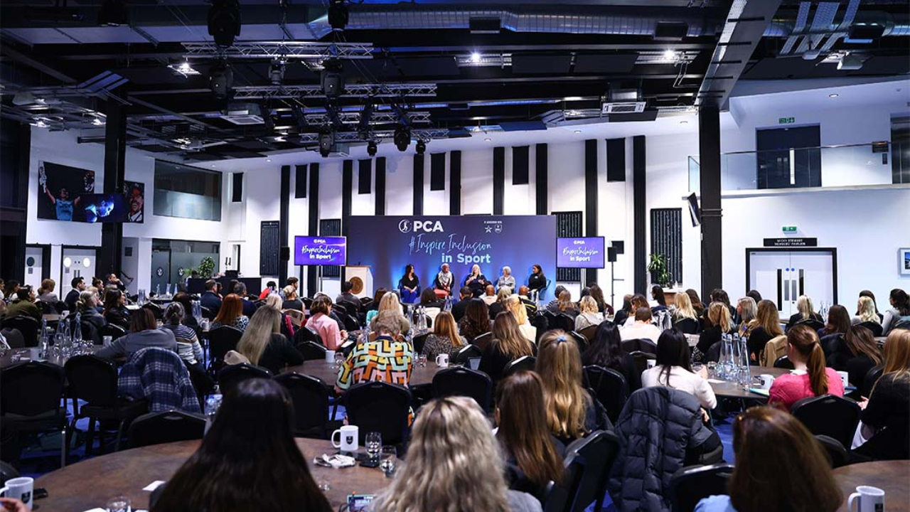 Audience attending the PCA International Women’s Day event focused on inspiring inclusion in sport, with panelists on stage