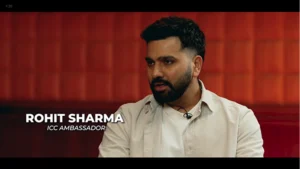 Rohit Sharma speaking during an interview as ICC Ambassador, seated against a red background