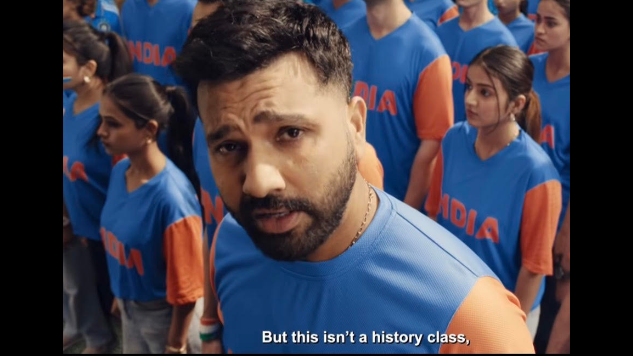 Rohit Sharma speaks to the camera surrounded by Indian cricket fans wearing blue jerseys during a promotional campaign