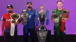 Sam Curran, Waqar Salamkheil, and Muhammad Waseem posing with championship belts and the DP World ILT20 trophy during a promotional event