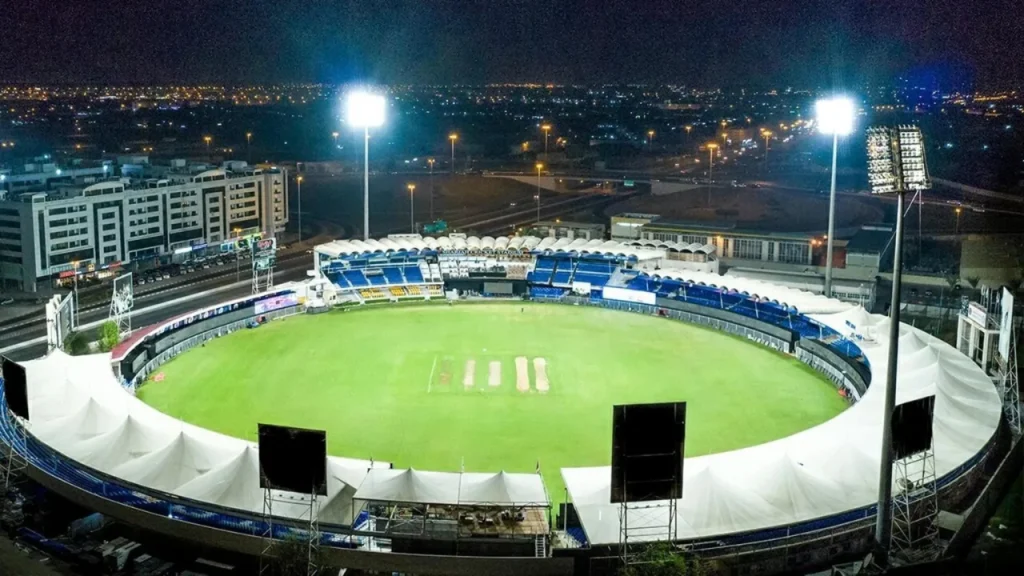 Sharjah Cricket Stadium illuminated at night during a cricket event in the UAE