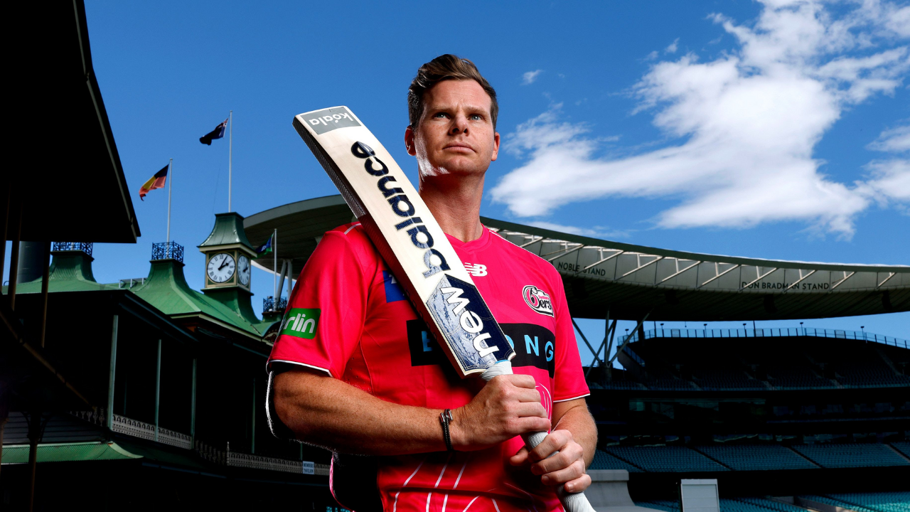 Steve Smith in Sydney Sixers jersey holding a cricket bat at the SCG ahead of BBL 2025