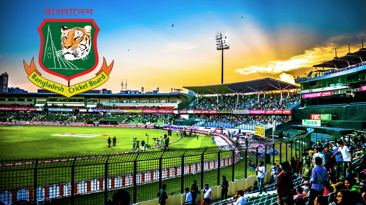 Bangladesh Cricket Board logo over Shere Bangla National Stadium in Dhaka during a cricket match with fans in attendance at sunset