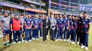 Jay Shah, U.S. Ambassador to India Sergio Gor, and the USA squad pose together during the ICC Men’s T20 World Cup 2026 at a stadium.