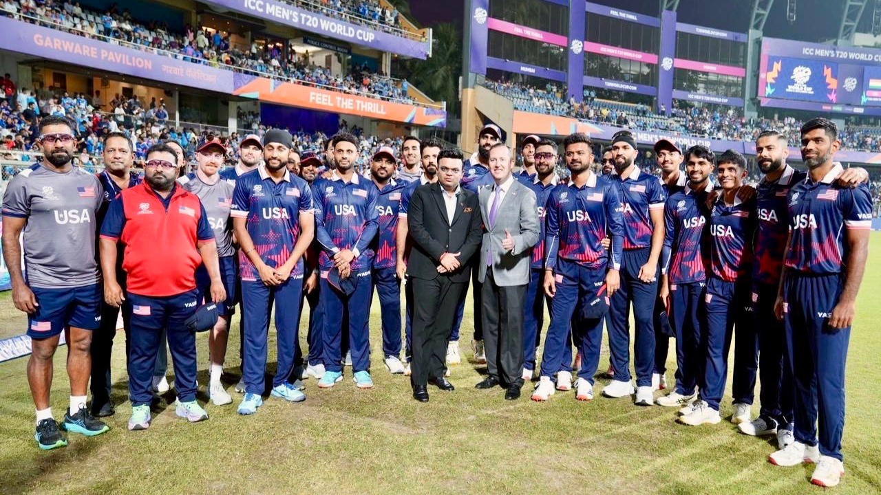 Jay Shah, U.S. Ambassador to India Sergio Gor, and the USA squad pose together during the ICC Men’s T20 World Cup 2026 at a stadium.