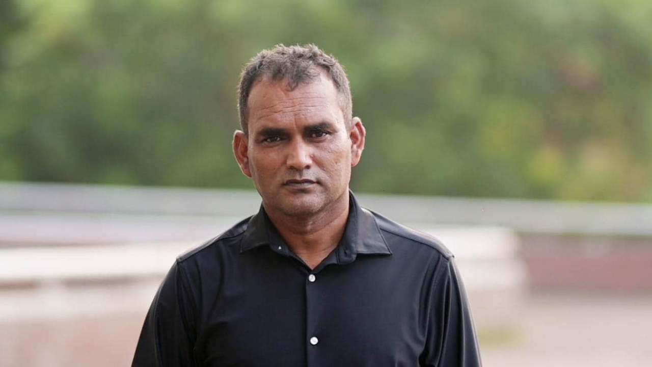 Mohammad Salahuddin, Bangladesh cricket coach, posing for a portrait in a black shirt outdoors.