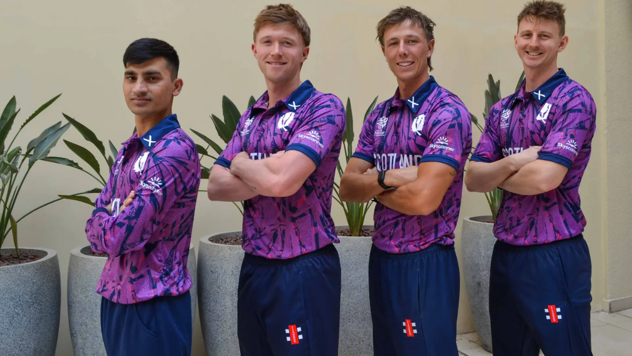 Scotland men’s cricket team players wearing the official T20 World Cup 2026 jersey featuring Skyscanner as the sponsor, posing with arms crossed.