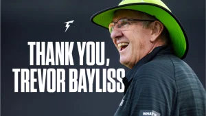 Trevor Bayliss smiling in a green hat with “Thank You, Trevor Bayliss” tribute text in the background.