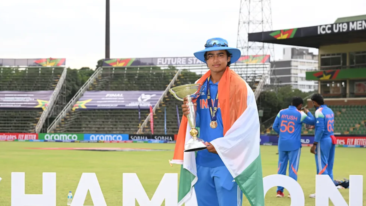 Vaibhav Sooryavanshi holds the ICC U19 World Cup 2026 trophy, draped in the Indian flag after India’s victory in the final.