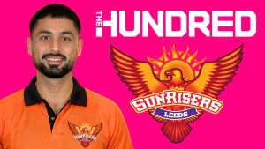 Abrar Ahmed in Sunrisers Leeds shirt with The Hundred and Sunrisers Leeds logos on a pink background.
