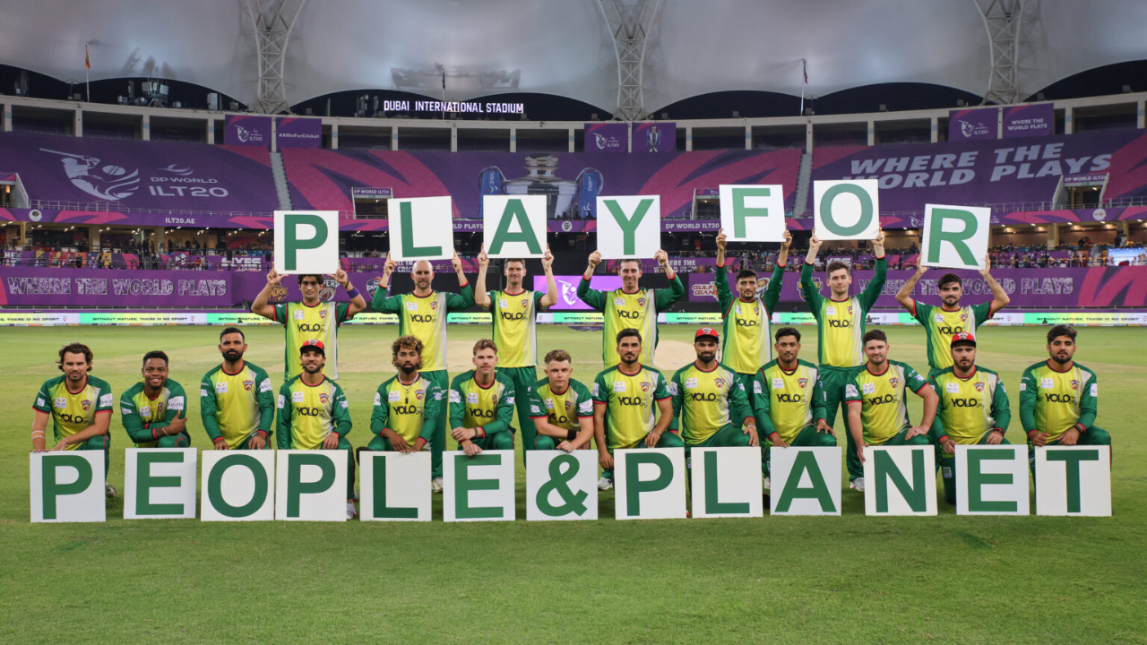 Desert Vipers team posing with “Play for People & Planet” signs at Dubai International Stadium during ILT20 match