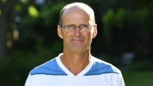 Portrait of Gary Kirsten, former South Africa cricketer and cricket coach, wearing glasses and a sports shirt outdoors.