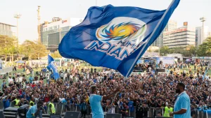 Hardik Pandya waving Mumbai Indians flag at The Mix fan event with large crowd of supporters in background