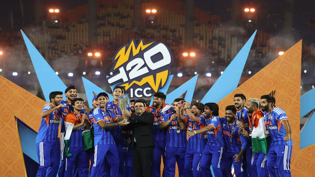 India cricket team celebrating on stage as Jay Shah presents the ICC Men’s T20 World Cup trophy after their championship victory.