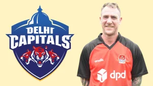 John Mooney pictured alongside Delhi Capitals logo, representing coaching or staff association with the IPL franchise