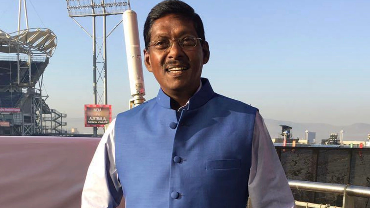 Laxman Sivaramakrishnan former Indian cricketer and commentator standing at a cricket stadium venue