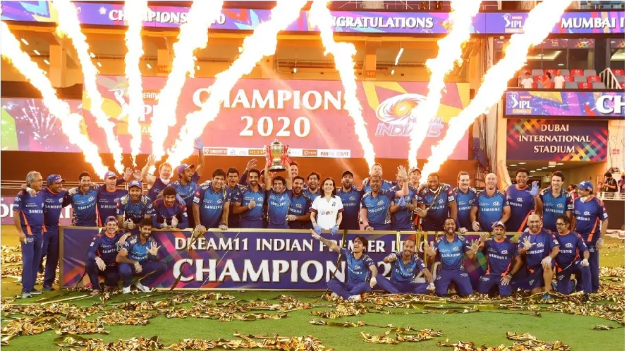 Mumbai Indians players celebrating IPL 2020 championship victory with trophy and fireworks at Dubai International Stadium