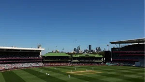 Sydney Cricket Ground in Australia during a live cricket match with players on the field and city skyline in background