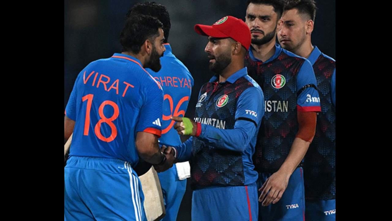 Virat Kohli interacts with Afghanistan cricket players during an international ICC match moment on the field.