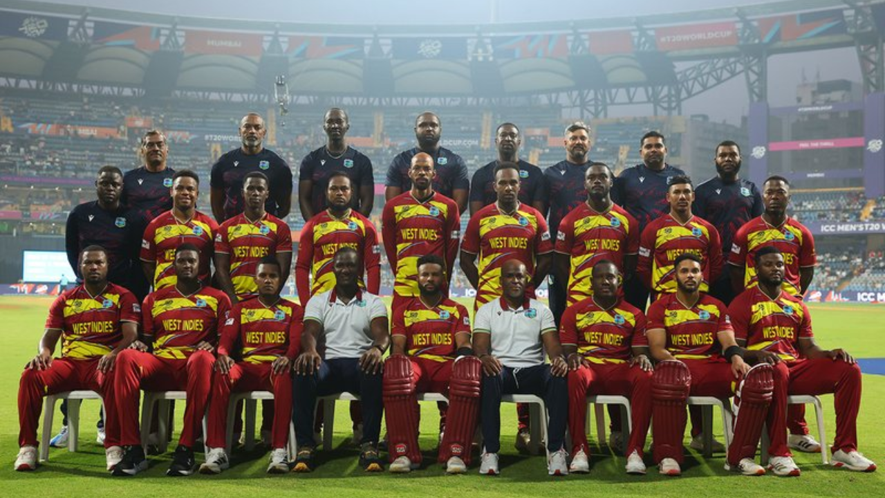West Indies cricket team squad with coaches and management staff posing for an official team photo at the ICC Men’s T20 World Cup 2026 in a cricket stadium.