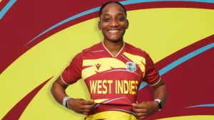 West Indies women’s cricket player poses in official team jersey with West Indies logo and colors displayed.