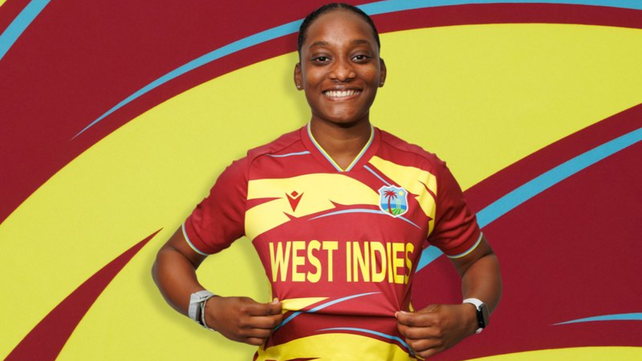 West Indies women’s cricket player poses in official team jersey with West Indies logo and colors displayed.