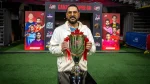 Yuvraj Singh holding Canada Super 60 cricket trophy during event launch with team posters in background