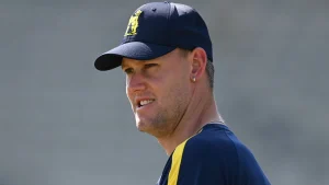 Beau Webster wearing Warwickshire cricket training kit and cap during practice session close-up portrait