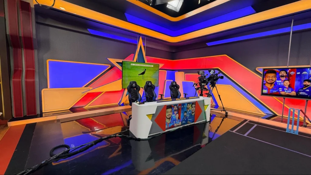 Cricket TV studio analysis set with broadcast desk cameras screens and lighting setup for IPL coverage