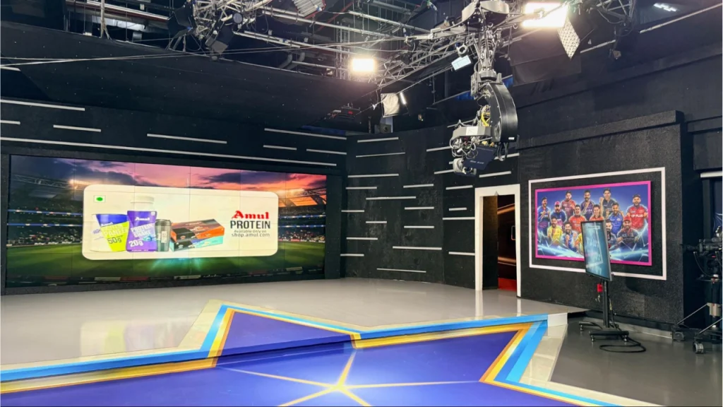 Modern cricket TV studio set with LED display screen broadcast cameras lighting rig and production setup