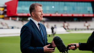 Lancashire Cricket chief executive Daniel Gidney being interviewed pitchside at a cricket ground with a microphone during a media session.