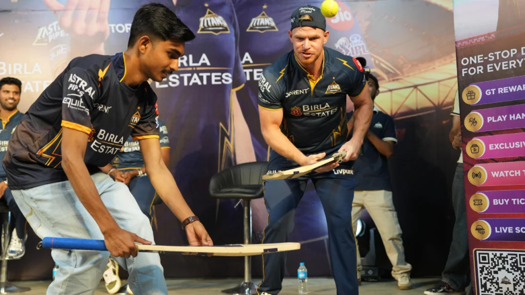 Glenn Phillips of Gujarat Titans playing a fun cricket game with a fan during a promotional event at Frizbee Food Park