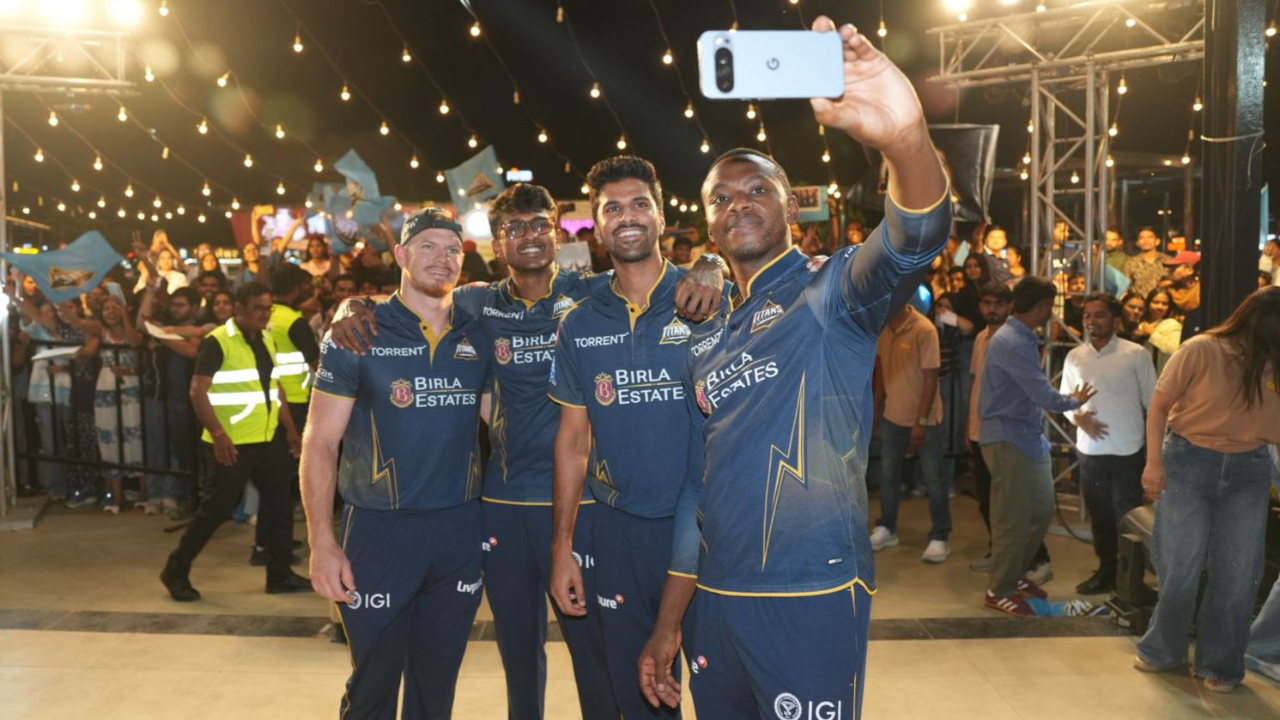 Gujarat Titans players Sai Sudharsan, Washington Sundar, Glenn Phillips and Kagiso Rabada taking a selfie with fans at Frizbee Food Park event under lights