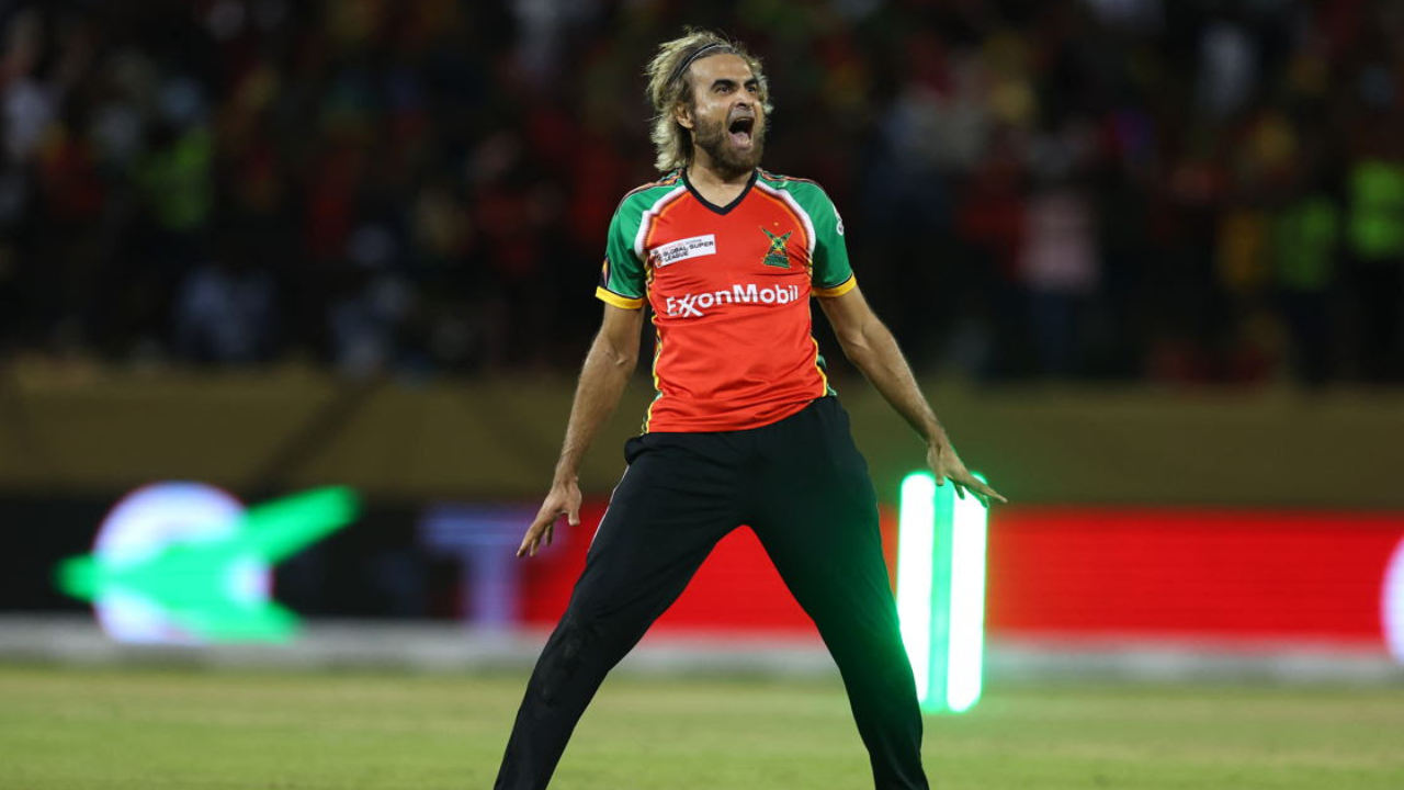 Imran Tahir celebrates during a CPL match wearing Guyana Amazon Warriors jersey on the field.