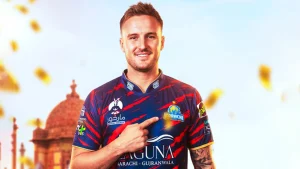 Jason Roy wearing Karachi Kings jersey pointing to team logo in PSL promotional image with landmark background