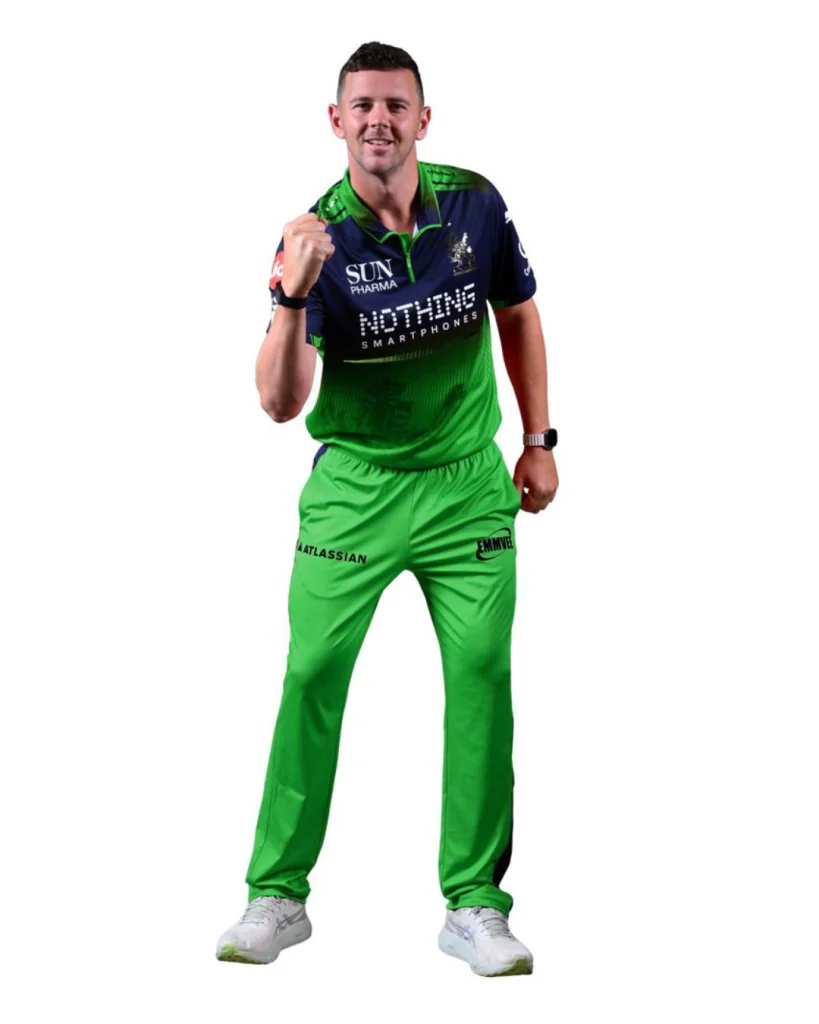 Josh Hazlewood in RCB green jersey celebrating with clenched fist during IPL photoshoot on white background