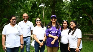 Juhi Chawla with KKR Runs to Roots initiative team during a tree plantation event in a green park setting